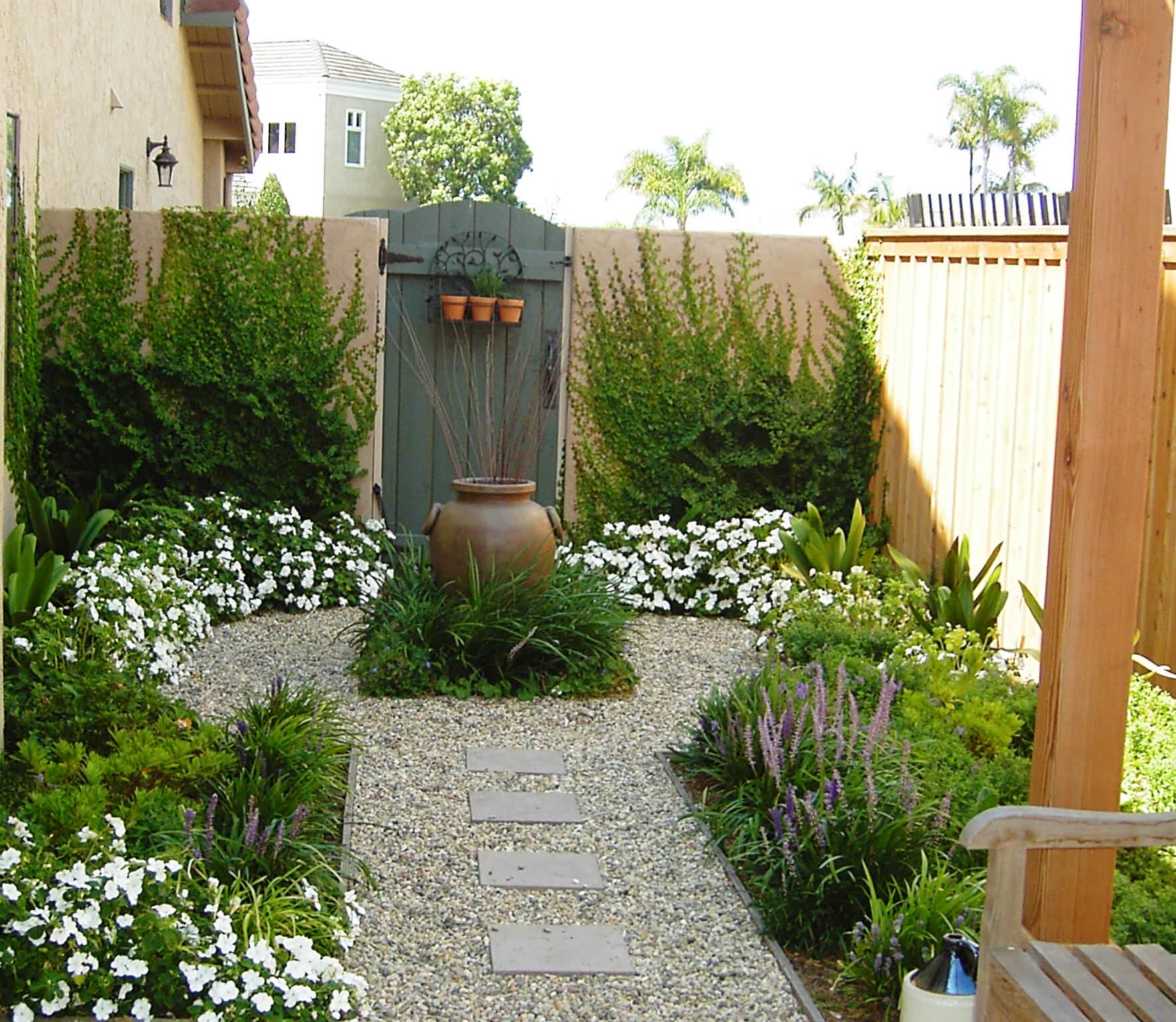 Skilled landscaper inspecting plant beds and lawn edges with professional tools